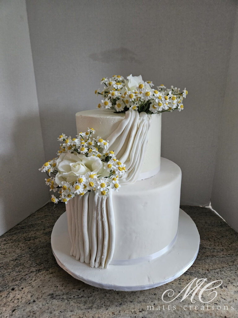 white wedding cake with delicate flowers